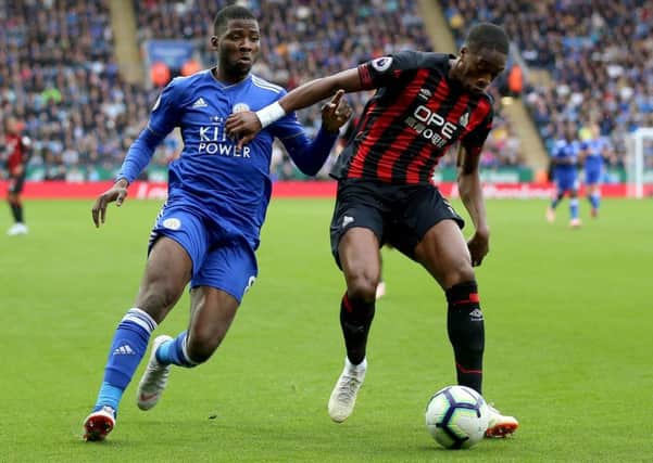 Leicester City's Kelechi Iheanacho (left) and Huddersfield Town's Terence Kongolo battle for the ball (Picture: PA)