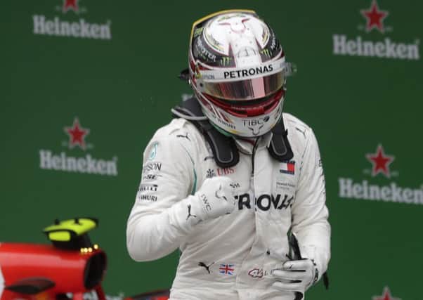 Mercedes driver Lewis Hamilton, of Britain, celebrates after winning the Brazilian Formula One Grand Prix.
