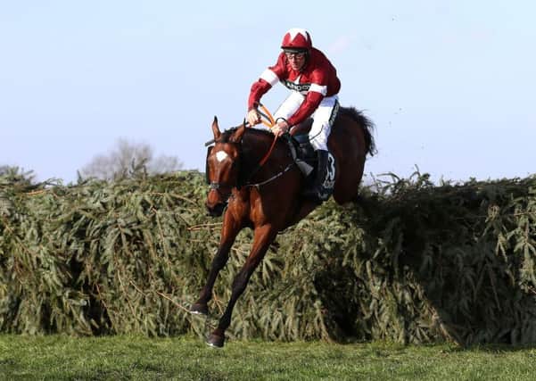 Tiger Roll ridden by Jockey Davy Russell on the way to winning the Randox Health Grand National Handicap Chase last April.