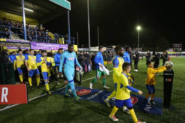 Haringey Borough's captain David Olufemi leads his team out against AFC Wimbledon in the FA Cup first round at the Coles Park Stadium on Friday. Picture: Nigel French/PA