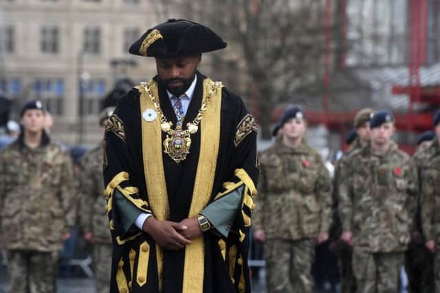 Lord Mayor of Sheffield Coun Magid Magid, wearing a white poppy, at the remembrance parade at Barkers Pool.