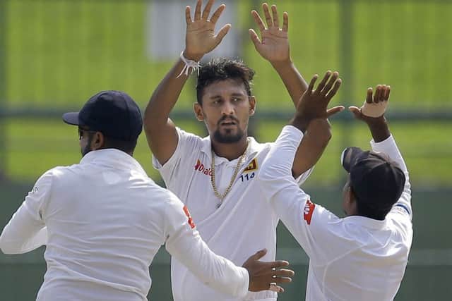 Sri Lanka's Suranga Lakmal, center, celebrates taking the wicket of England's Keaton Jennings with teammates in Pallekele. Picture: AP/Eranga Jayawardena