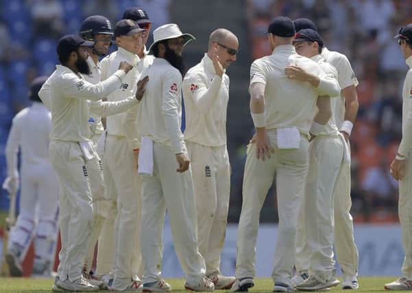 England's Jack Leach, center, is congratulated by his team mates for taking the wicket of Sri Lanka's Kusal Mendis. Picture: AP/Eranga Jayawardena.
