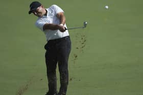 Italy's Francesco Molinari plays a shot on the 1st hole during the first round of the DP World Tour Championship golf tournament in Dubai, United Arab Emirates. (AP Photo/Kamran Jebreili)