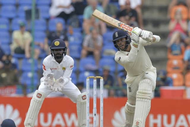 England's Ben Foakes plays a cover drive as Sri Lankan wicketkeeper Niroshan Dickwella watches in Pallekele. Picture: AP/Eranga Jayawardena
