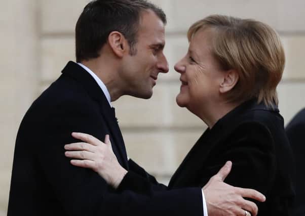French President Emmanuel Macron hugs German Chancellor Angela Merkel in Paris last weekend ahead of a ceremony to mark the 100th anniversary of the end of the Great War. (AP).