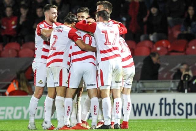 Winner: Doncaster Rovers players celebrate Tommy Rowe's strike.