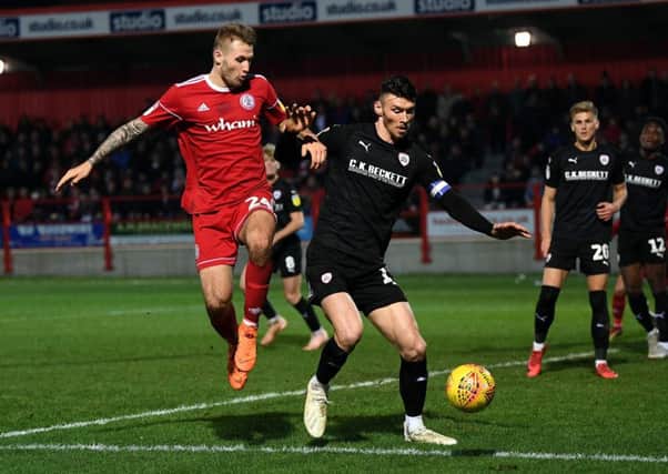 On the attack: 
Barnsley's Kieffer Moore takes on Accrington's Nick Anderton. 
Picture : Jonathan Gawthorpe