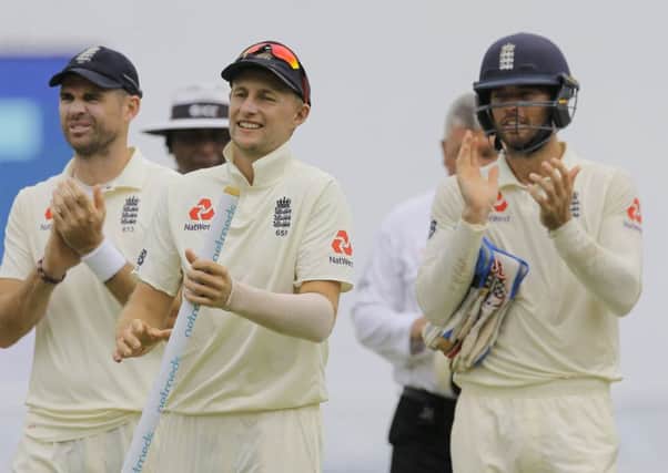 England's captain Joe Root, center, James Anderson, left, and Ben Foakes celebrate their victory over Sri Lanka by 57 runs in Pallekele. Picture: AP/Eranga Jayawardena.