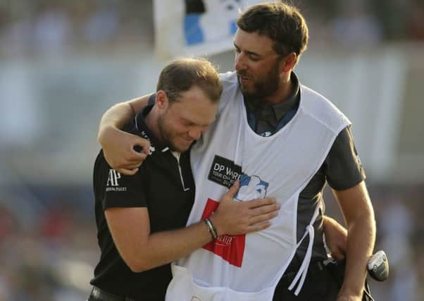 end game: Englands Danny Willett hugs his caddy after winning the DP World Tour Championship golf tournament in Dubai.  Picture: AP/Kamran Jebreili.