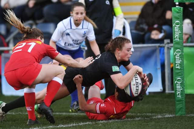 England's Kelly Smith gets away from Canada's Magali Harvey to score a try. 
Picture: Jonathan Gawthorpe