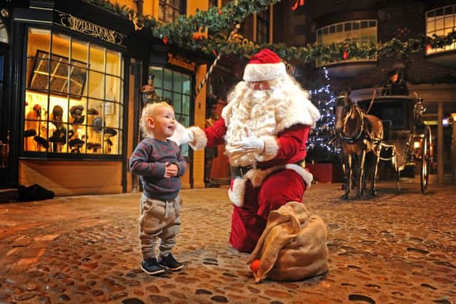 Little Milo Richardson meets Santa Claus at York Castle Museum.  Picture: Tony Johnson.