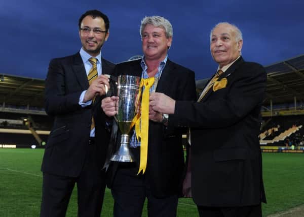 Ehab Allam, left, seen in May, 2013 at the club's promotion party with then manager Steve Bruce and Assem Allam along with the Championship runners-up trophy.