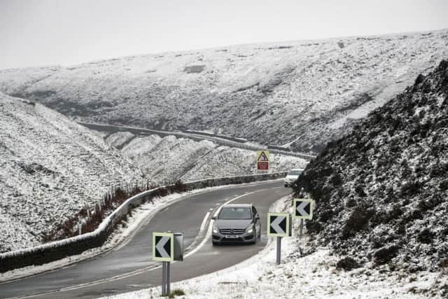 A car navigates the Snake Pass in Derbyshire, as a blast of snow hits the north of England on Wednesday. Picture: Danny Lawson/PA Wire