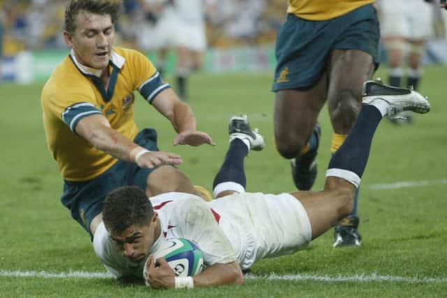 Jason Robinson evades the challenge of Mat Rogers to touch down against the Wallabies in Sydney. (PA)