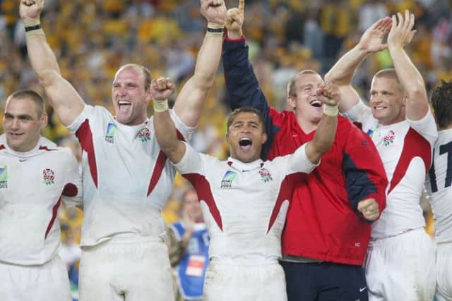 England's Jason Robinson (centre) heads the celebrations with team-mates after beating Australia in the Rugby World Cup Final in 2003.