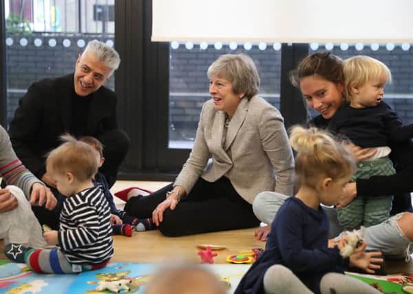 Theresa May at a parent and toddler group before updating MPs on Brexit.