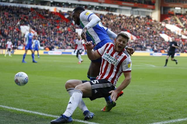 Cheyenne Dunkley of Wigan Athletic challenges Jack O'Connell of Sheffield United during the recent Sky Bet Championship match (Picture: Simon Bellis/Sportimage)