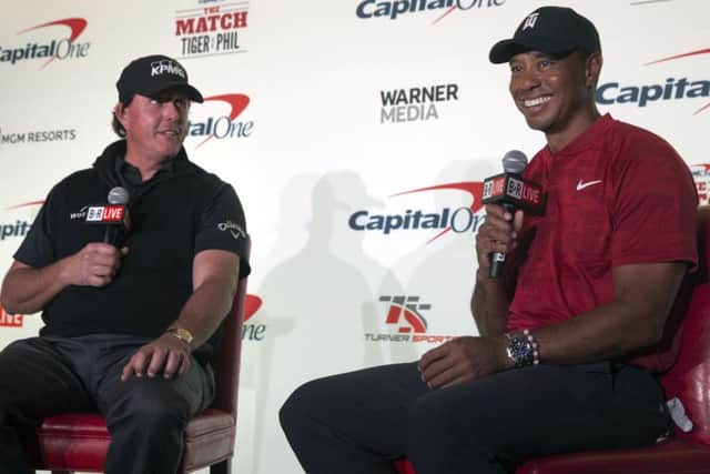 Phil Mickelson, left, and Tiger Woods speak during a news conference  at Shadow Creek Golf Course in North Las Vegas. (Steve Marcus/Las Vegas Sun via AP)