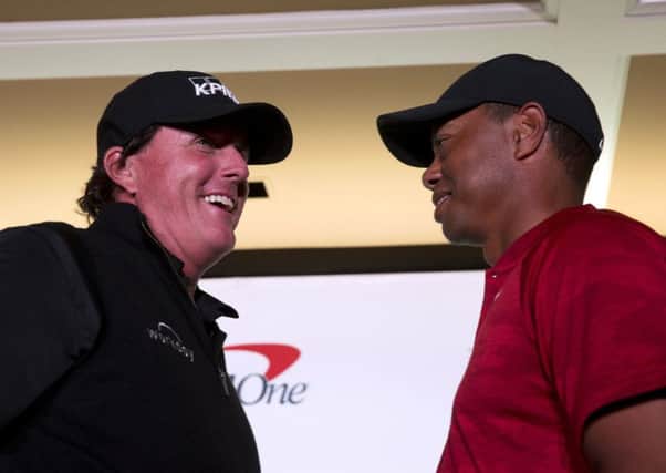Phil Mickelson, left, and Tiger Woods face off during a news conference at Shadow Creek Golf Course in North Las Vegas. (Steve Marcus/Las Vegas Sun via AP)