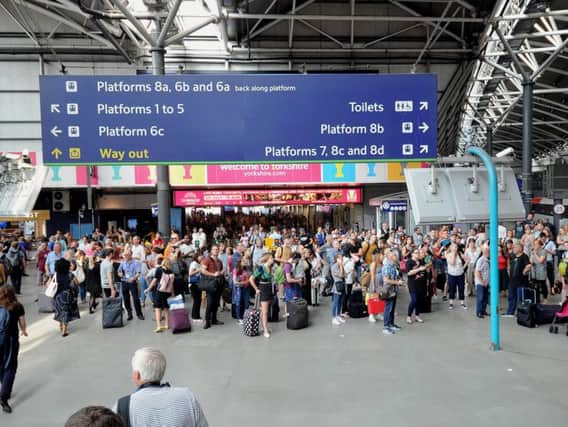 Passengers wait for service announcements at Leeds railway station. Picture: Simon Hulme