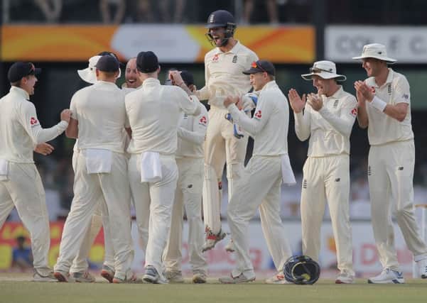 England players celebrate the dismissal of Sri Lanka's Dhananjaya de Silva during the third day of the third test cricket match between Sri Lanka and England in Colombo.