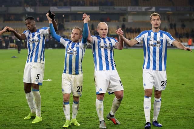 Huddersfield Town's Terence Kongolo, Alex Pritchard, Aaron Mooy and Jon Gorenc Stankovic celebrate in front of their fans after during the Premier League match at Molineux (Picture: Nick Potts/PA Wire)