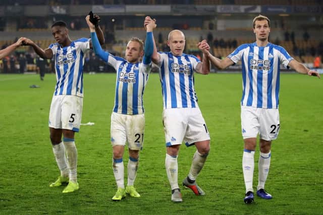 GOOD DAY (left to right): Huddersfield Town's Terence Kongolo, Alex Pritchard, Aaron Mooy and Jon Gorenc Stankoviccelebrate in front of their fans at Molineux. Picture: Nick Potts/PA