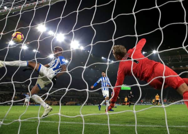 Huddersfield Town's Philip Billing (left) clears the ball from the goal line following a headed attempt by Wolves' Raul Jimenez and a save from Huddersfield Town goalkeeper Jonas Lossl. Picture: Nick Potts/PA