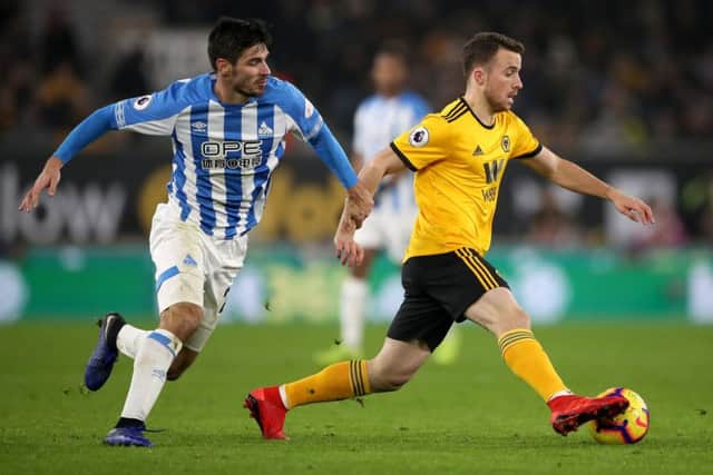 Huddersfield Town's Christopher Schindler (left) and Wolverhampton Wanderers' Diogo Jota battle for the ball at Molineux. Picture: Nick Potts/PA