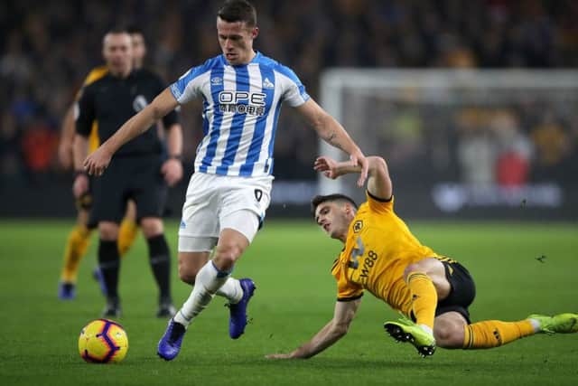 Huddersfield Town's Jonathan Hogg (left) and Wolverhampton Wanderers' Ruben Vinagre battle for the ball at Molineux. Picture: Nick Potts/PA