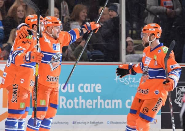 FROM ME, TO YOU: Evan McGrath, right, comes to congratulate Steffan Della Rovere after helping set him up to score Sheffield Steelers' third goal against Manchester Storm on Sunday. Picture: Dean Woolley.