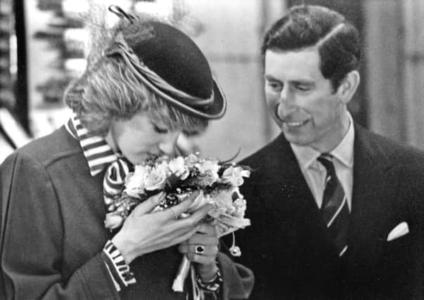 Prince Charles and Princess Diana admire a bouquet by florist Annie Valentine, March 15, 1984.