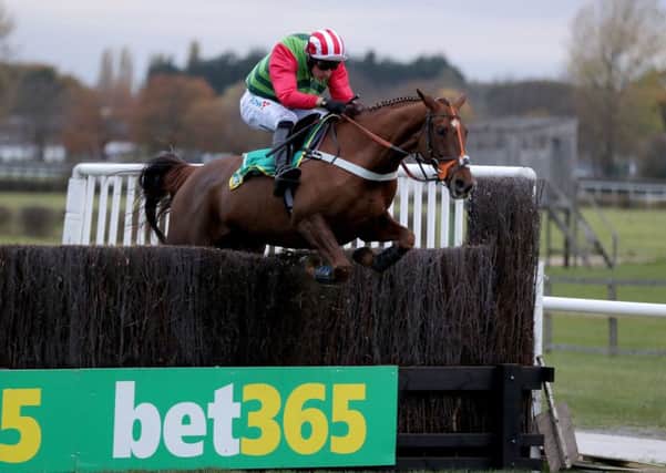 Danny Cook and Definitly Red clear the last in the Charlie Hall Chase at Wetherby.