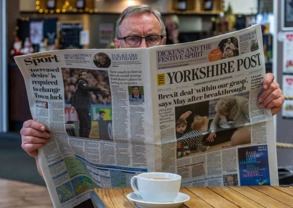 A reader enjoys a recent edition of The Yorkshire Post in a cafe.