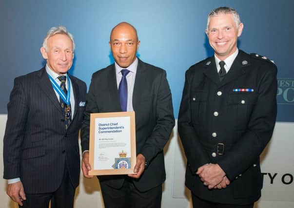 Det Con Ray Evans, centre, receives his Outstanding Contribution to Policing Award from High Sheriff Richard Jackson and Chief Supt Steve Cotter.
