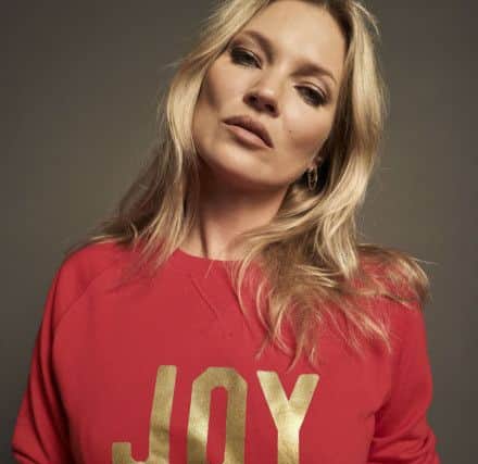 Kate Moss supports Save the Children in Selfish Mother JOY sweatshirt for Christmas Jumper Day, Â£55, with a 50 per cent donation to Save the Children, at theFMLYstore.com.