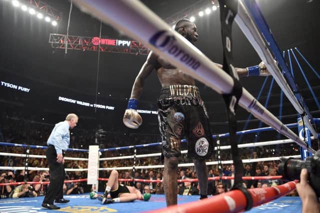 Down but not out:  Tyson Fury is floored by Deontay Wilder.