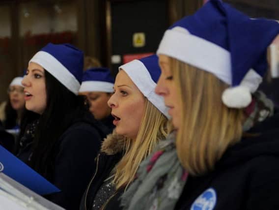 Lucy's Pop Choir singing Christmas carols in Leeds Railway Station