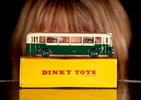 ALL ABOARD: Clockwise from top, Susan Riley examining a die-cast London bus on her stall at the toy fair at York Racecourse. PIC: Charlotte Graham
