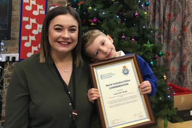 Lucas Carter Wright, 5, pictured with mum Alex and his commendation after calling 999
