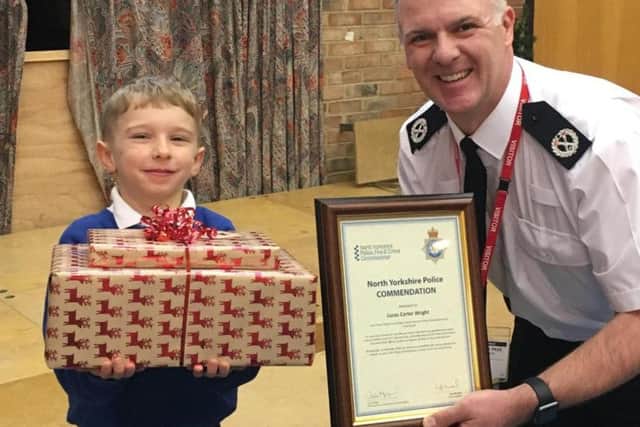 North Yorkshire Police Assistant Chief Constable Ciaron Irvine meets Lucas, 5, and gives him a Christmas present in recognition of his bravery