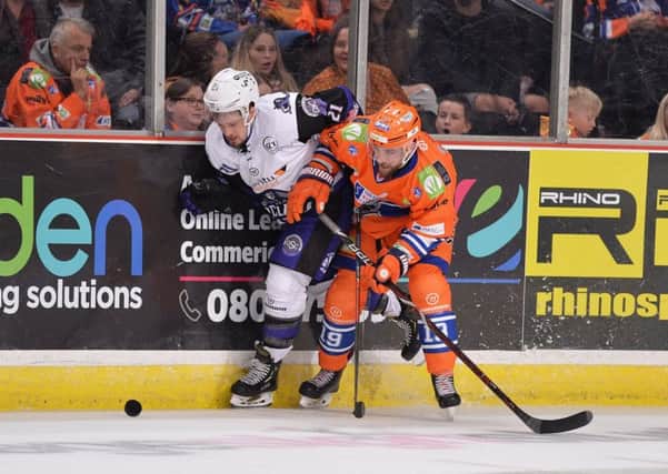 Evan McGrath battles on the boards in this season's Sheffield Arena clash with Glasgow Clan. Picture: Dean Woolley.