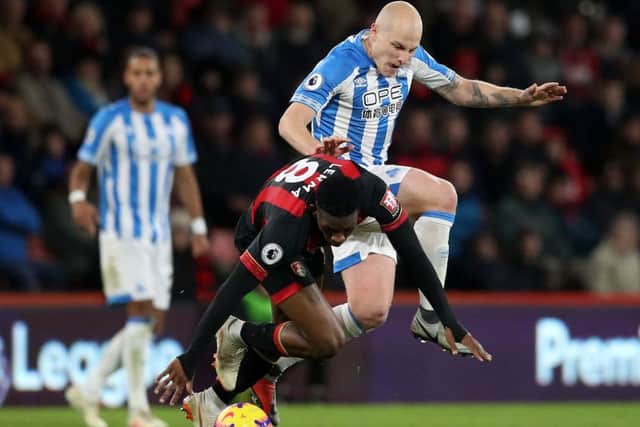 Bournemouth's Jefferson Lerma (left) and Huddersfield Town's Aaron Mooy battle for the ball. Picture: Adam Davy/PA