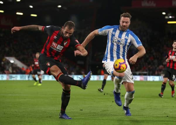 Bournemouth's Steve Cook (left) and Huddersfield Town's Laurent Depoitre fight for possession at Dean Court. Picture: Adam Davy/PA