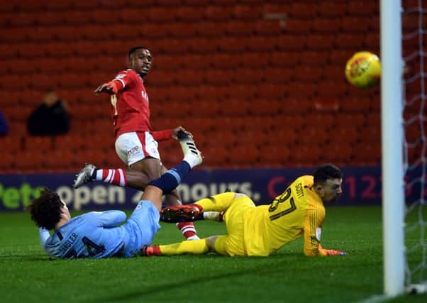Barnsley's Victor Adeboyejo beats Manchester City's goalkeeper Thomas Scott to open the scoring.
 Picture: Jonathan Gawthorpe