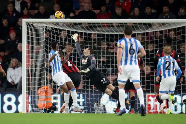 HEAD TENNIS: Huddersfield Town's Terence Kongolo (center) scores his side's goal against Bournemouth at Dean Court. Picture: Adam Davy/PA