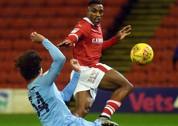 On target: Barnsley's Victor Adeboyejo beats Manchester City's Philippe Sandler to open the scoring. 
Picture: Jonathan Gawthorpe