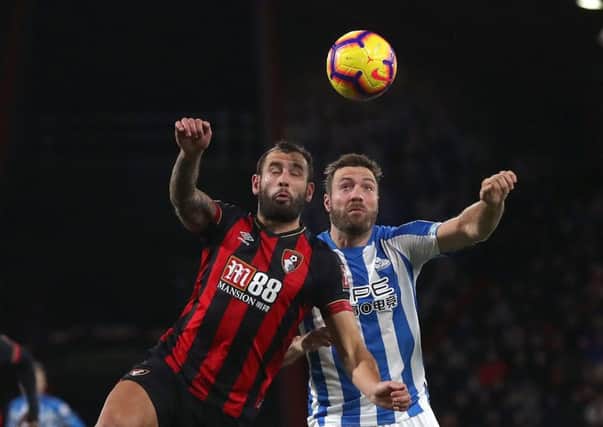 Bournemouth's Steve Cook (left) and Huddersfield Town's Laurent Depoitre battle for the ball during the Premier League match (Picture: Adam Davy/PA Wire)
