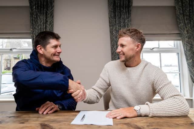 STICKING AROUND: Yorkshire County Cricket Club's Joe Root is pictured with Director of Cricket Martyn Moxon as he signs a new contract with the club. Picture: Alex Whitehead/SWpix.com
